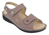 Pink sandal with a strap and decorative buckle on a white background
