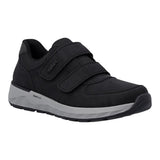 A black slip-on sneaker with two hook-and-loop straps and a gray and black sole, shown from a side profile on a white background.