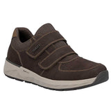 A dark brown slip-on shoe for children featuring two hook-and-loop straps, a thick light gray midsole, and a black outsole, shown on a plain white background.