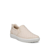 Beige slip-on sneaker with quilted pattern on a white background