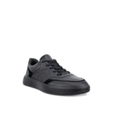 A black leather low-top sneaker with black laces and a chunky black sole, shown from a three-quarters angle on a white background.