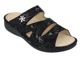 Black sandal with floral pattern on a white background