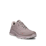 A single low-top athletic shoe in a muted taupe-gray color, featuring a textured synthetic upper, matching gray laces, and a rugged sole, shown against a plain white background.