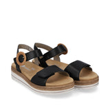 Black sandals with brown soles on a white background