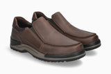 A pair of men's brown slip-on loafers with a textured leather upper and a thick, multi-toned black and gray sole, shown on a light gray background.