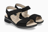 Black sandals with beige soles on a white background