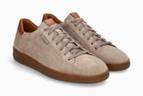 A pair of low-top suede sneakers in a light taupe-beige color with brown soles and brown leather accents on the collar and tongue. The brand name 'BONSAI' is visible in gold lettering on the side of the front shoe.