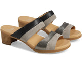 A pair of women's slide sandals with a block heel, featuring color-blocked straps in black, metallic silver, and light gray suede, with a tan footbed and sole.