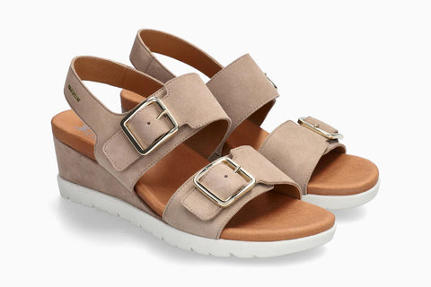 Beige wedge sandals with buckles on a white background