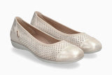 Pair of beige perforated shoes on a white background