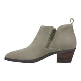 A single women's ankle boot in light taupe suede, featuring a side zipper with a gold-tone pull tab, a dark brown stacked block heel, and a black outsole, shown against a plain white background.